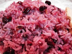 Cherry Rice: A plate of rice with cranberries on it.