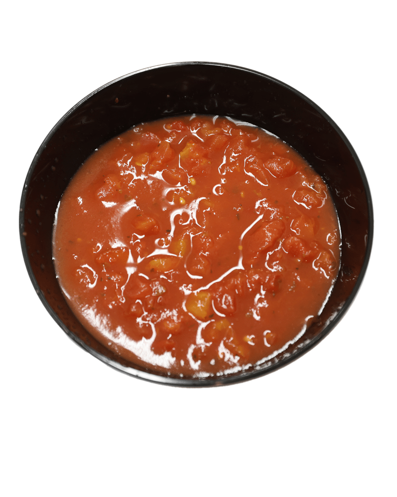 A bowl of tomato sauce with diced onions on a white background.