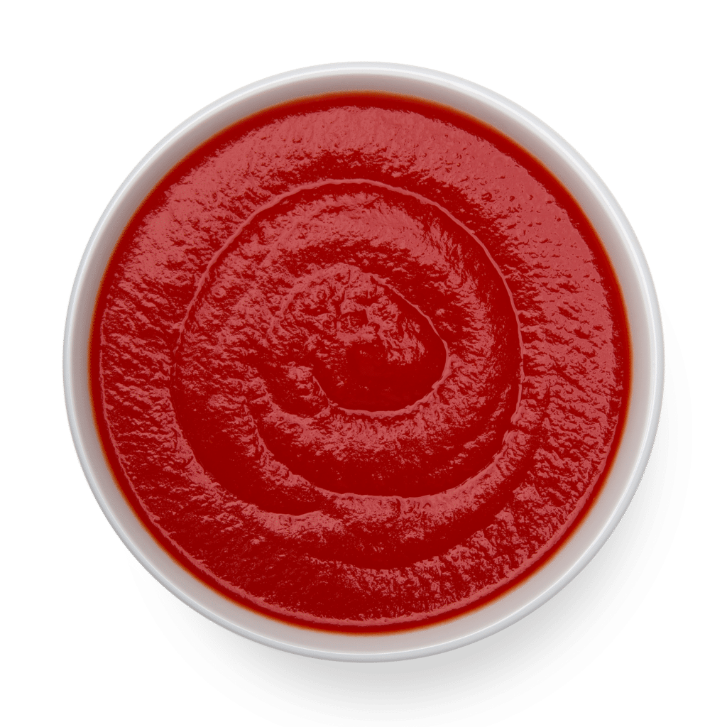 A red organic sauce in a bowl on a black background.
