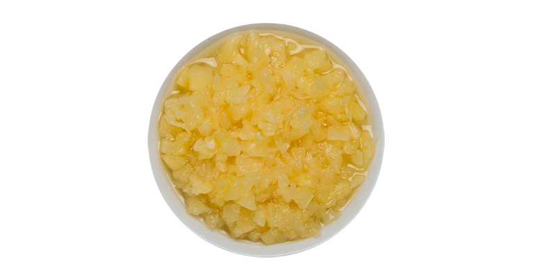 A bowl full of yellow sugar and crushed pineapple on a white background.