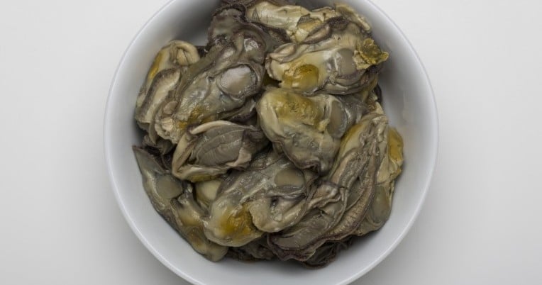 Fancy boiled oysters in brine presented in a white bowl.