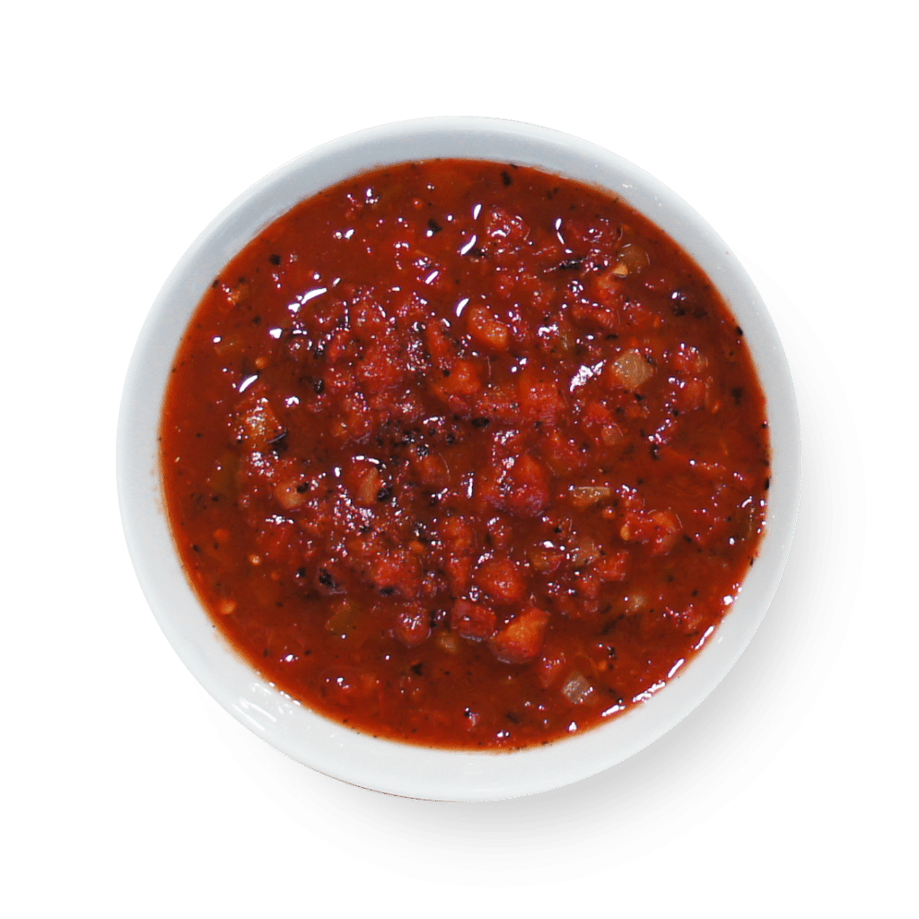 A bowl of fire roasted red sauce on a white background.