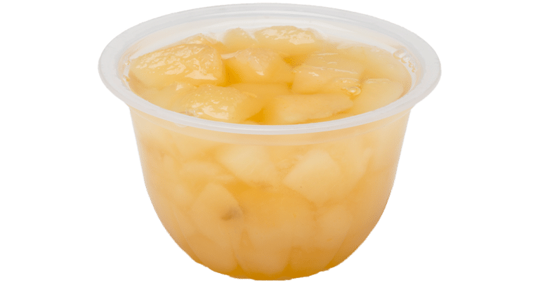 A cup of diced pineapples in light syrup on a white background.