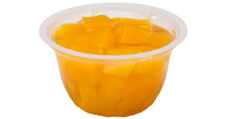 Diced mangoes served in a plastic cup on a white background.