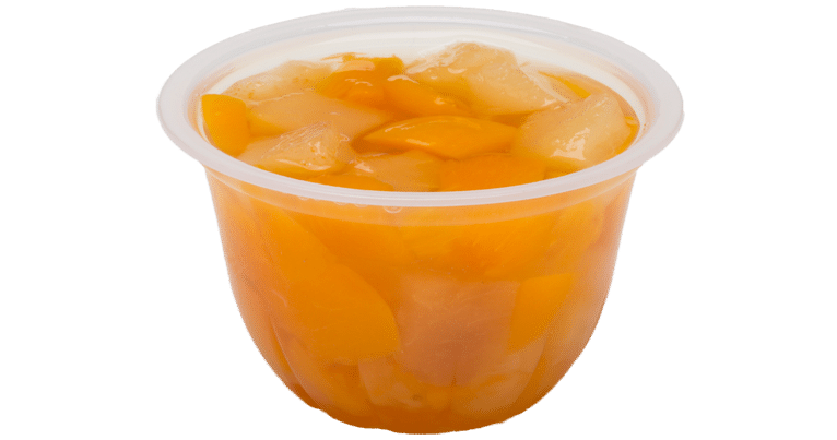 A cup of orange juice with diced peaches and pears in real fruit juice.
