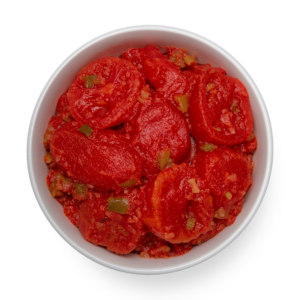 Stewed tomatoes in a bowl on a black background.