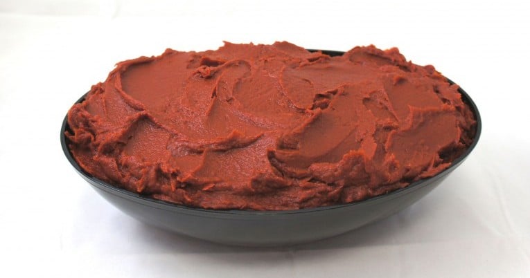 A bowl of red icing made with tomato paste.