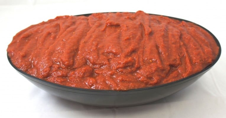 Red sauce in a #10 bowl on a white background.