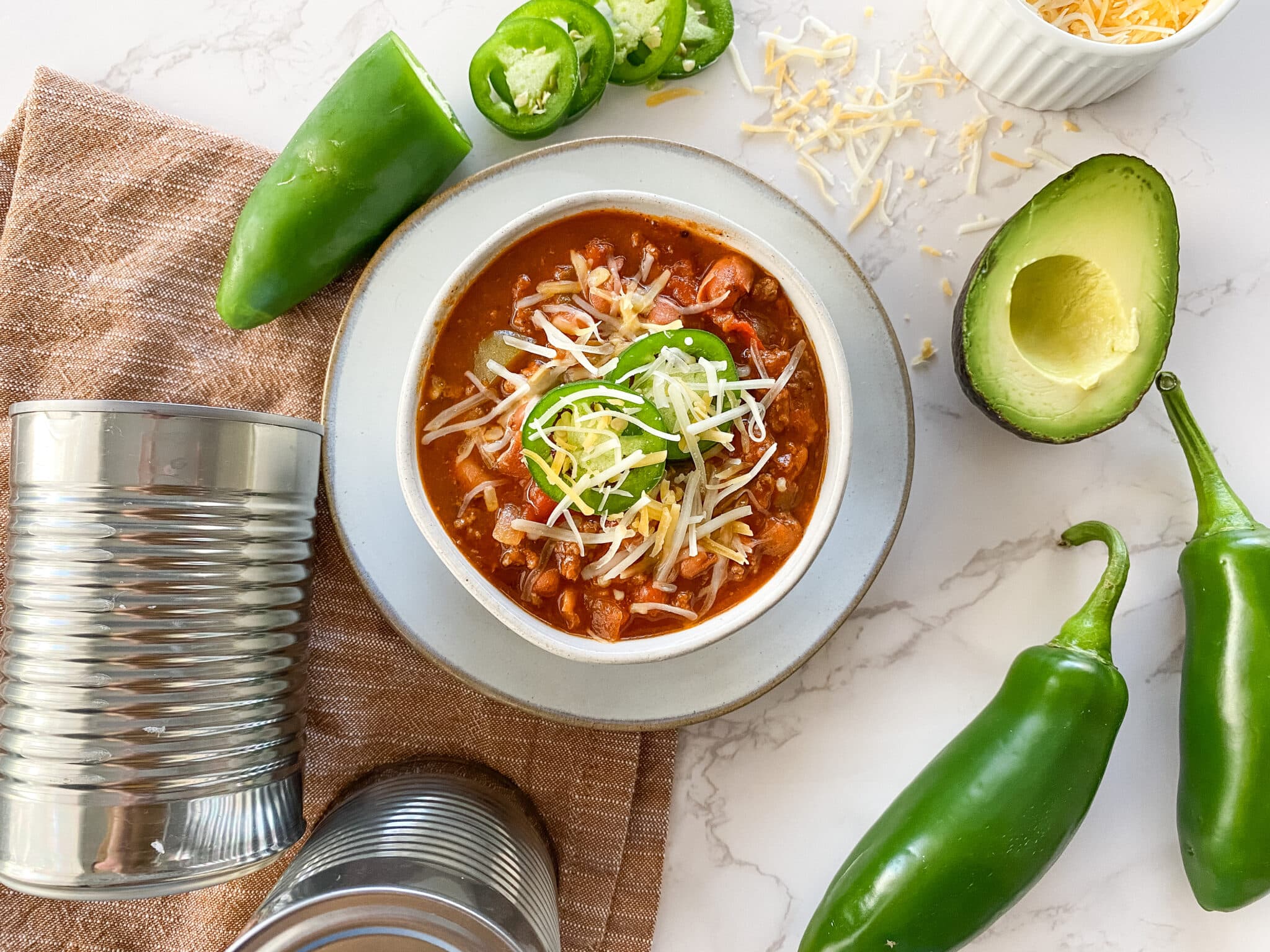 overhead recipe photo of chili in bowl with ingredients