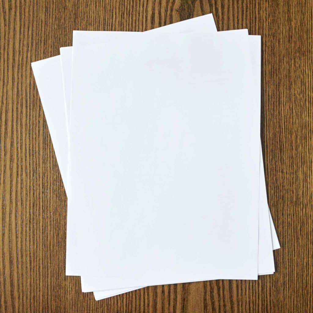 Upper shot of papers over a wooden table.