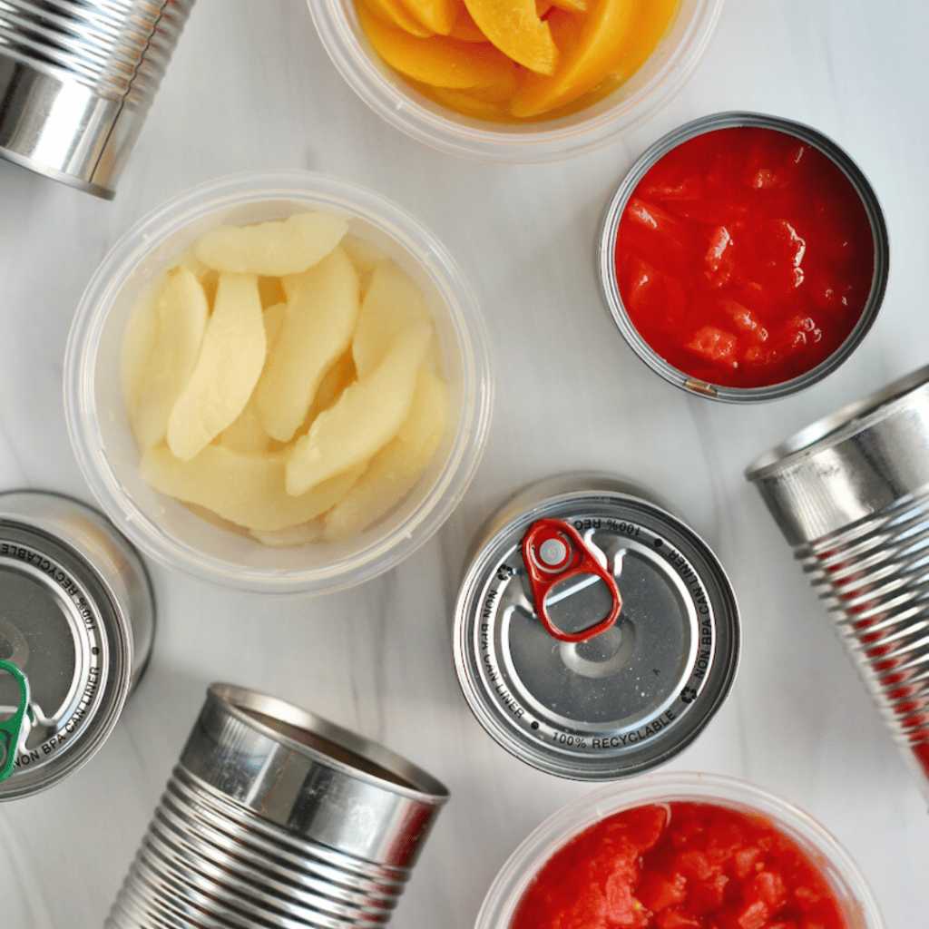 Upper shot with dishes with sliced fruit and canned fruit products